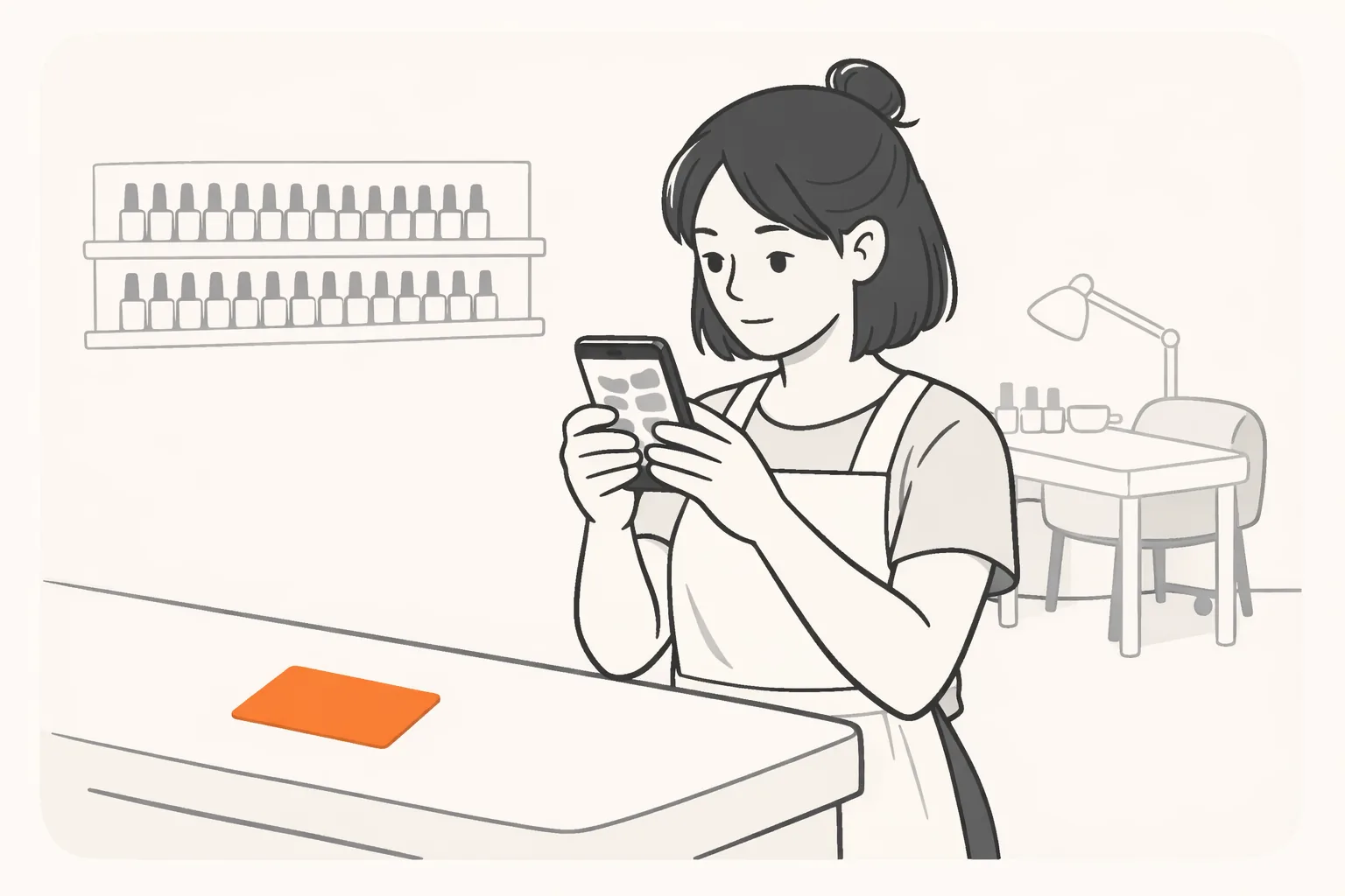 A nail technician at her salon front desk between clients, reading her phone closely, an orange card on the desk beside her